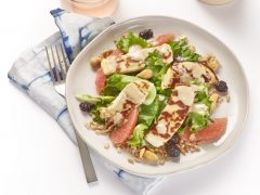 seared halloumi salad on a white plate with not just salad dressing