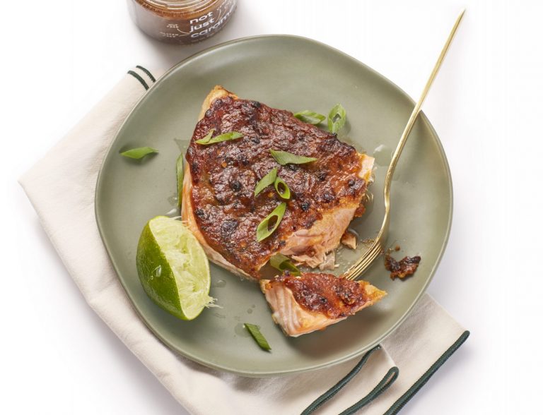 caramel glazed salmon on a green plate with lime wedge