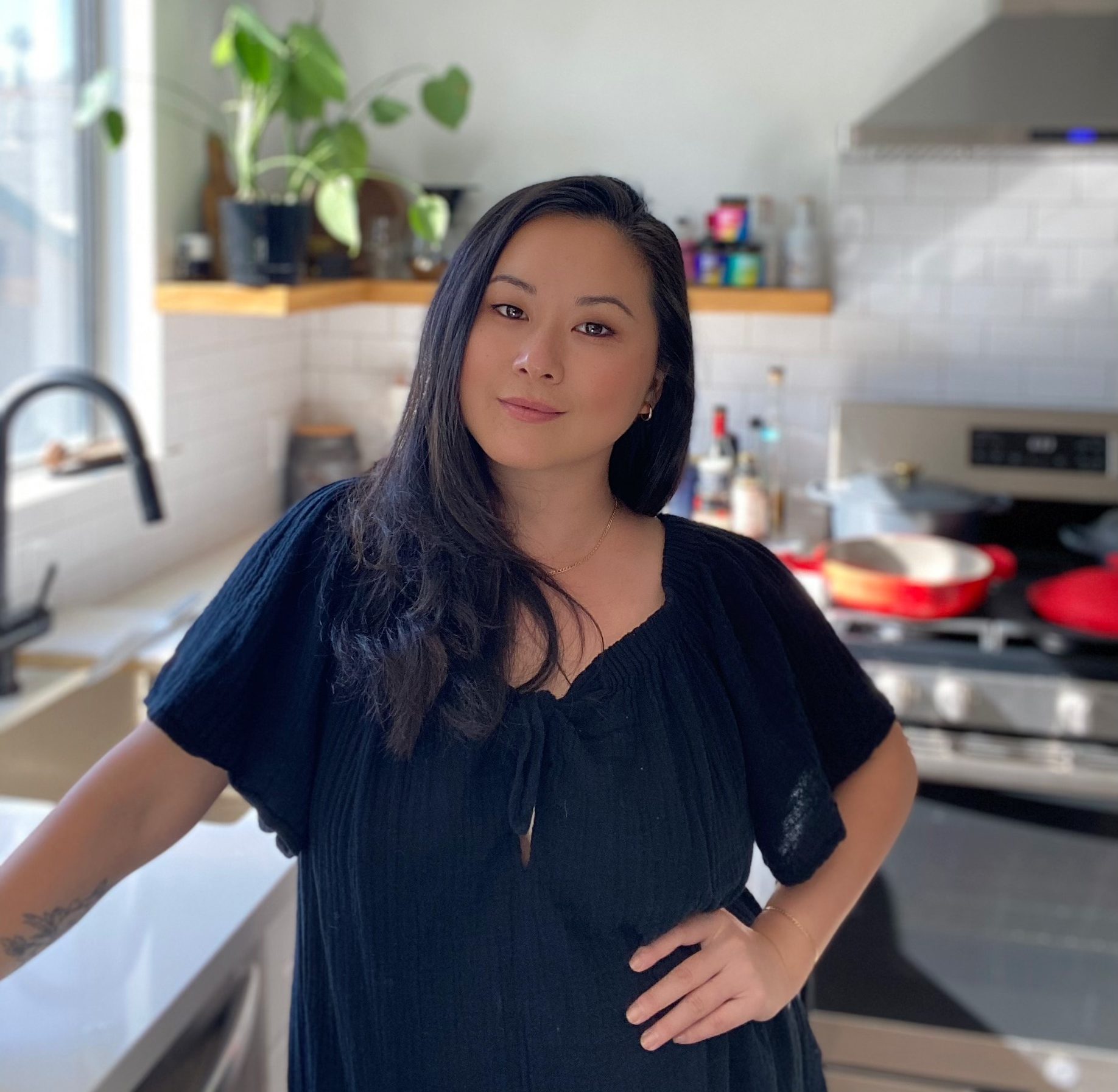 Photograph of Fly by Jing Founder Jing Gao standing in her kitchen