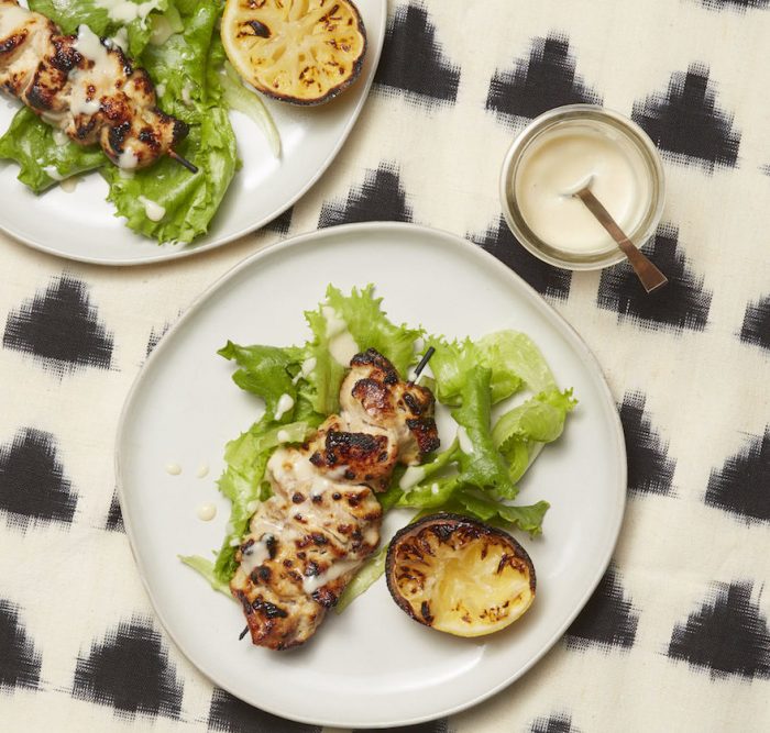 chicken skewers on black and white table cloth marinated in not just lemon miso salad dressing